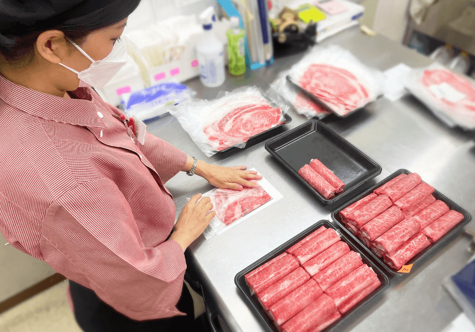 お肉をパッキングする女性社員